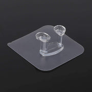 Modern interior featuring a transparent self-adhesive wall hook on a light wall.