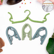 Foldable travel hangers hanging clothes in hotel room closet