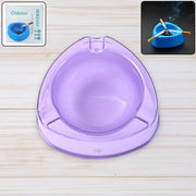 Transparent purple plastic ashtray with wide bowl and triangular shape