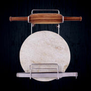 Elegant stainless steel stand securely holding a wooden rolling pin on a kitchen counter.