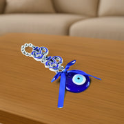 Close-up image of evil eye beads and satin ribbon on double OM hanging