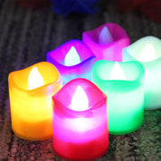 Hand holding a glowing LED tealight candle, showcasing its portability.