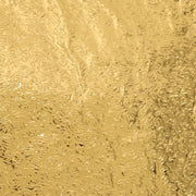 Close-up of a self-adhesive golden kitchen foil sticker roll.