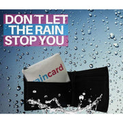 Individual wearing emergency raincoat card outdoors in wet weather