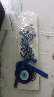 Double OM evil eye hanging displayed indoors enhancing vastu energy