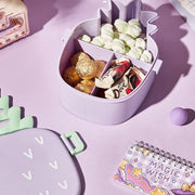 A child's pineapple bento box filled with colorful sushi and fresh fruits.