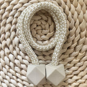 Pair of hexagonal magnetic curtain tiebacks elegantly holding a sheer curtain.