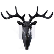 White deer head self-adhesive wall hook attached to a door, ready for use.