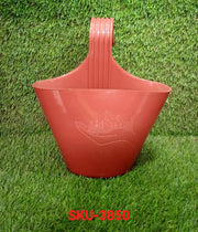 Single hanging planter pot on a balcony railing.