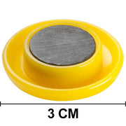 Collection of colorful circular board magnets on a flat surface.