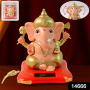Solar Ganesha idol figurine enclosed in a transparent protective box with vibrant base