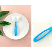 Happy child brushing teeth with a blue U-shaped toothbrush.