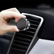 Rotating magnetic phone holder holding smartphone inside vehicle
