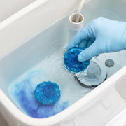 Long-lasting toilet cleaner block in use in the cistern