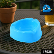 Plastic ashtray placed on outdoor patio table
