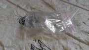Silicone magnetic nose clip resting on surface before use