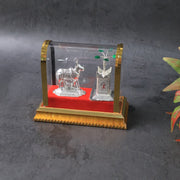 Close-up of Kamdhenu cow and Tulsi plant idol showing intricate silver plating